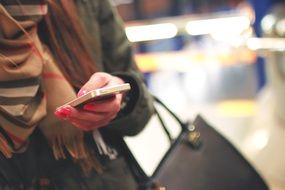 iPhone in the hand of a woman on the street
