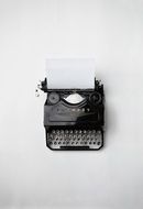 vintage black typewriter with paper inserted