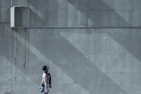 hipster girl near the concrete wall