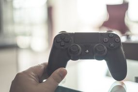 game controller playstation in hand