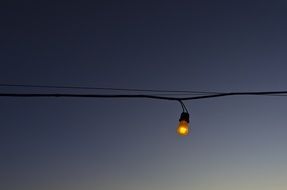 yellow light bulb on the wire