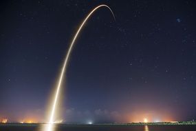 rocket launch trajectory at night sky