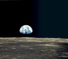 view of earth planet in space from moon surface