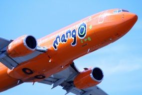 orange plane on a background of blue sky