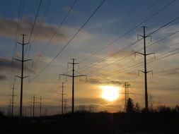 twilight over power lines among nature in canada