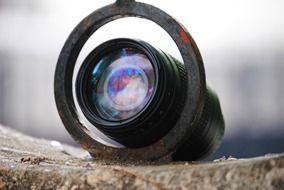 a lens in a metal ring on a stone