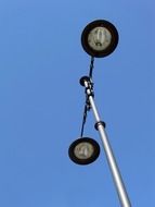 street lighting with two lamps against a blue sky