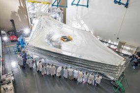 picture of the space telescope and scientists