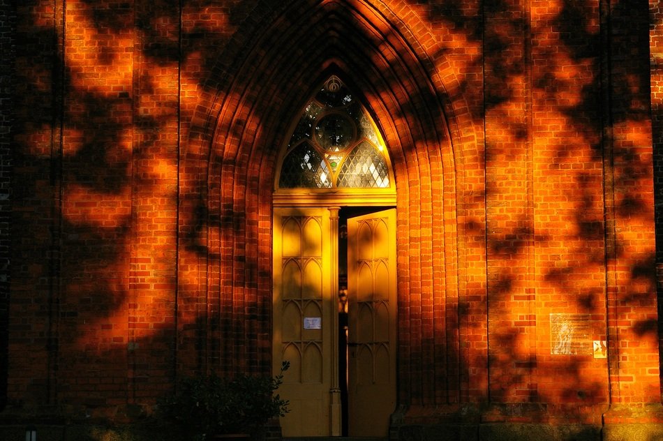The doors of the chapel in the glare of the setting sun