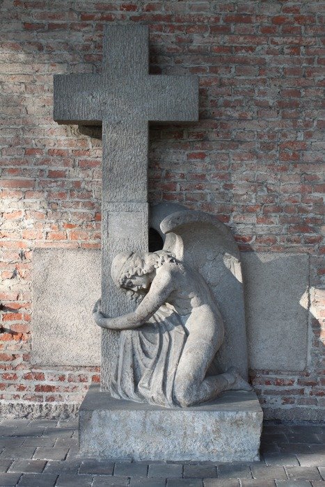 sculpture of an angel near the cross