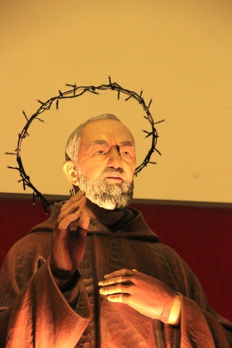 priest and crown of thorns statue