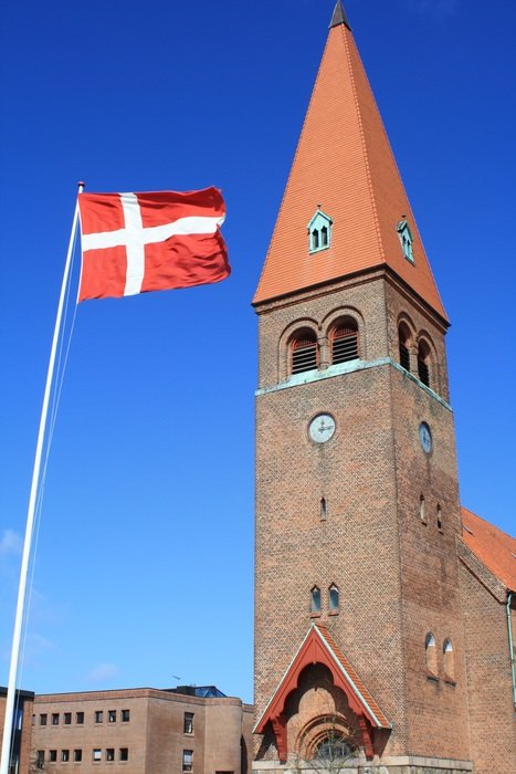 flag on the background of the church in Denmark