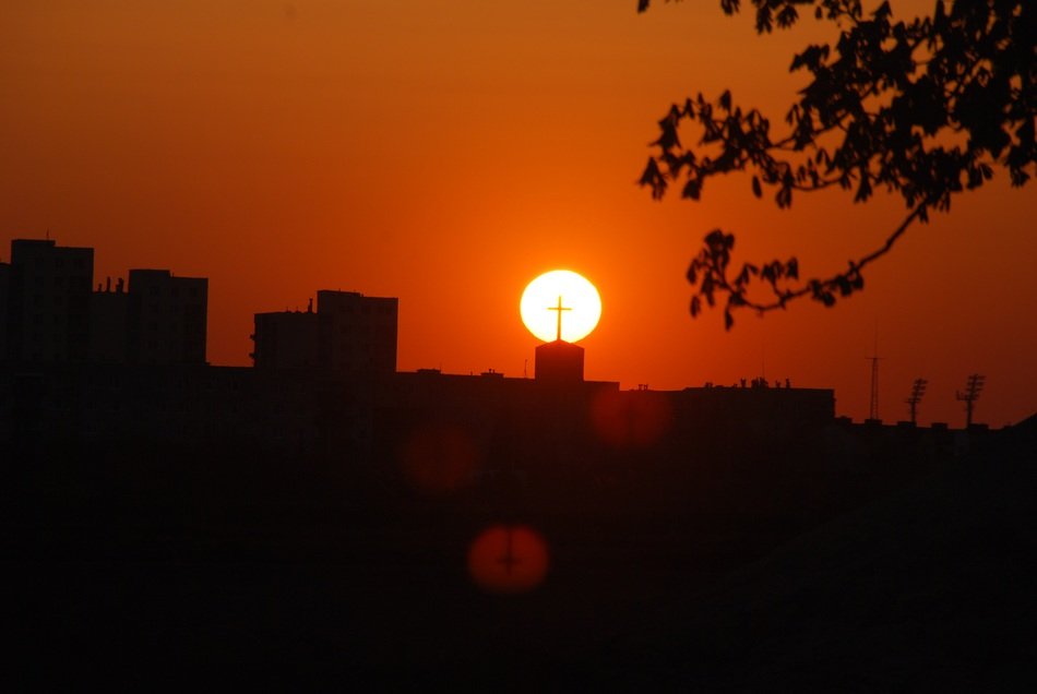 bright sun in the sunset on the background of the church