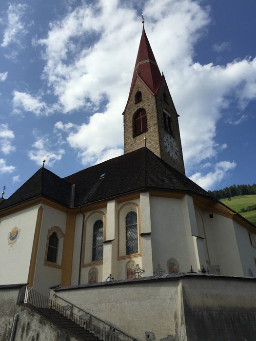 church with a spire on the background of clouds