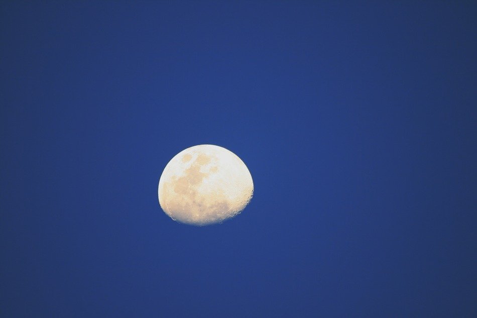photo of part of the moon against a dark blue sky