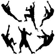 Silhouettes Of Six Climbers Bouldering At An Indoor Climbing Gym