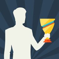 Silhouette of man holding prize cup