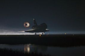 space shuttle landing at night