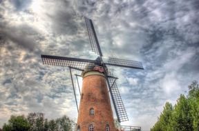 Windmill on the background of a cloudy sky