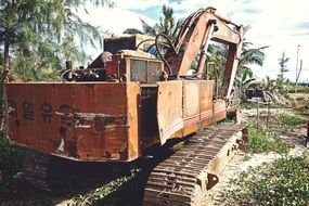 rusty excavator on construction site