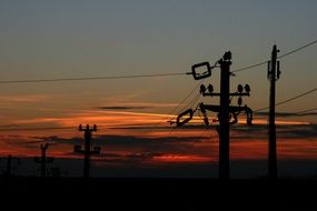 electric poles at the backround of sunset