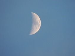 growing moon in a clear sky
