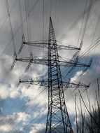 electricity pylon against a cloudy sky