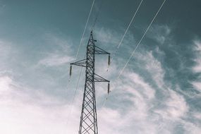 electric pole with wires against a cloudy sky