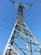 high transmission tower with wires at sky