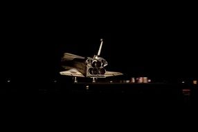 shuttle on the runway at night