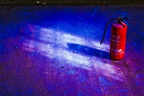 fire extinguisher in a room in colorful lighting