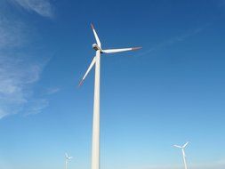 wind turbine on a background of blue sky with clouds