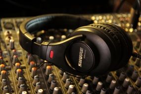 Headphones are on the mixer in sound studio