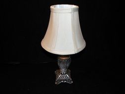 antique table lamp on black background