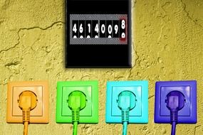 multi-colored sockets on a yellow wall