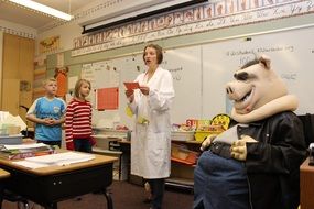 man in pig costume in school lab