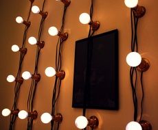 lamps and black screen on the wall