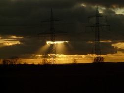 sun rays behind the clouds at dusk