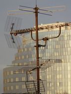 antennas on a mast on the roof of the house