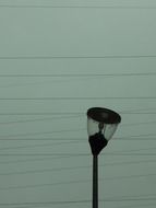 twisted street lantern and power lines
