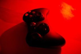 gaming joystick on red background