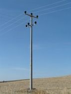Power line tower on a field