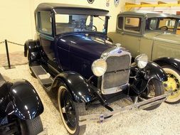 classic retro Ford cars in a museum