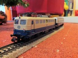 toy locomotive on railway in room