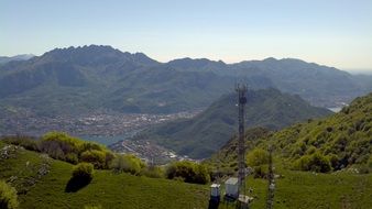 mobile antenna stands on a green hill