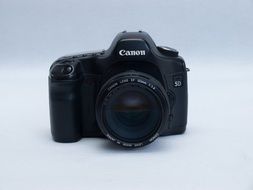 black camera on a white surface