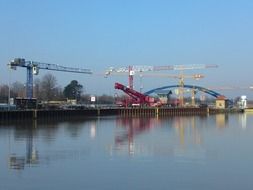 tower cranes and auto crane at channel, germany, dortmund