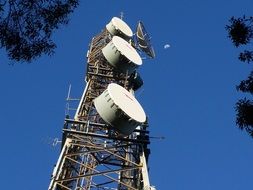 communcations devices on tower at sky