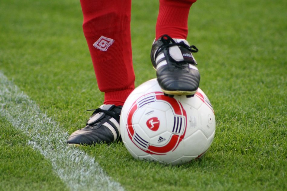 football field and foot with ball