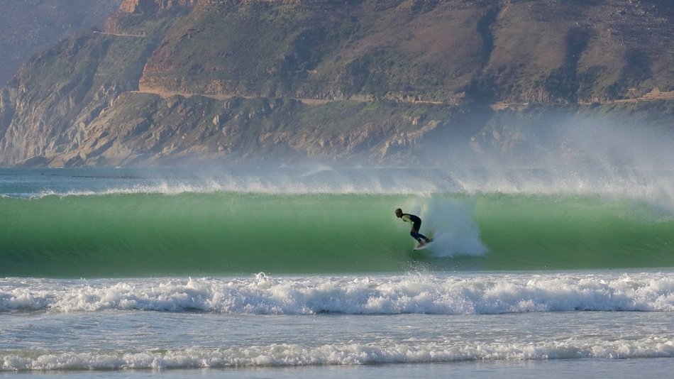 surfing at ocean wave dramatic view